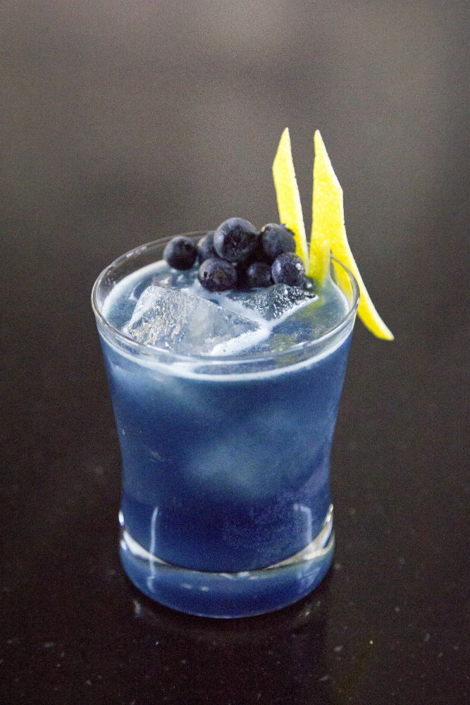 Blue cocktail with Damrack Gin, Bols Blue Curacao, lemon, blueberries and cardamom