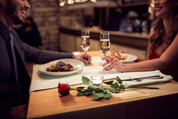 Couple enjoying Valentine's Day dinner with champagne