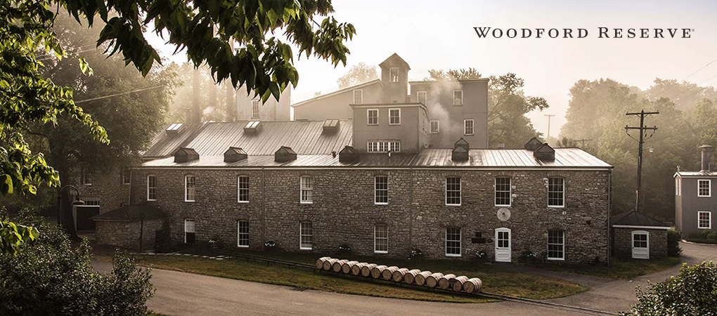 Woodford Reserve distillery grey stone building with leafy frame