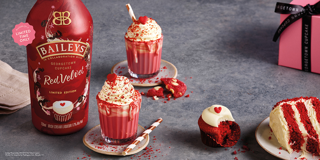 bottle of baileys red velvet next to red velvet lattes, cupcakes and cakes