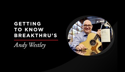 Copy that reads, 'Getting to know Breakthru's Andy Westley' with picture of man holding guitar with bottle of wine in foreground