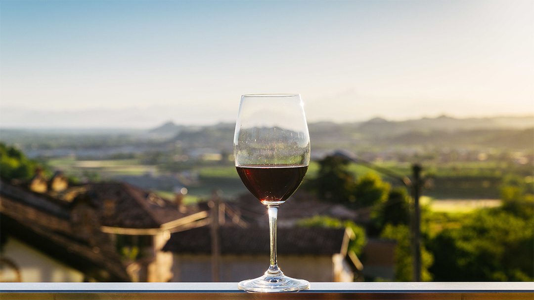 red wine glass on a ledge overlooking town