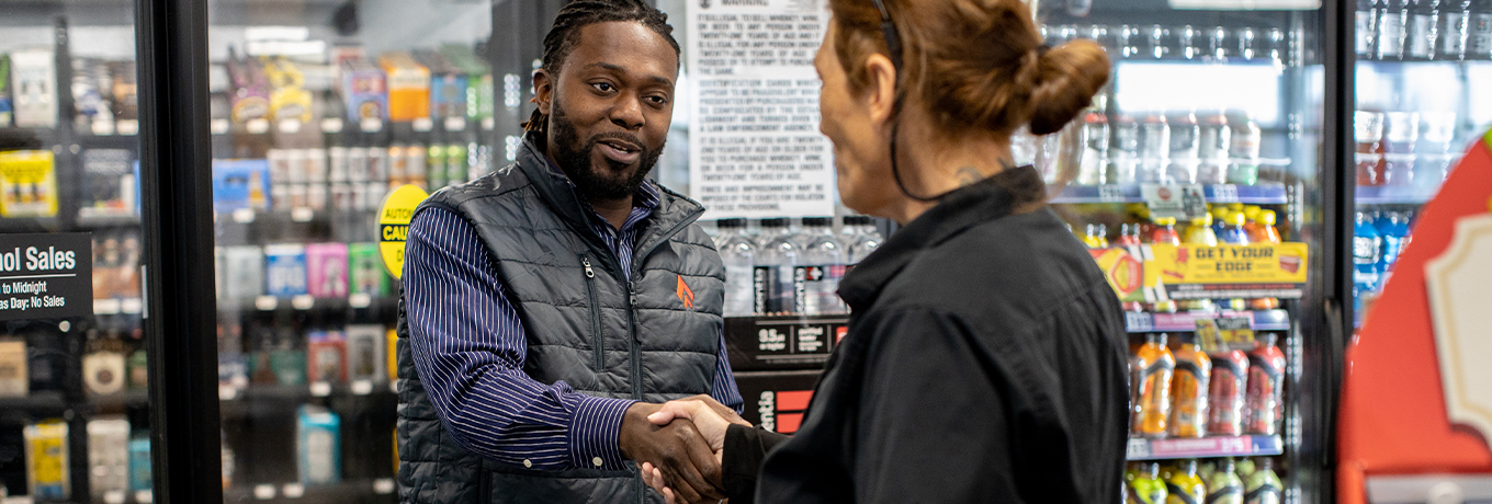 Male associate and store employee engaging with one another